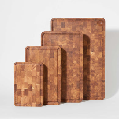 Four wooden cutting boards in sizes from small to extra large