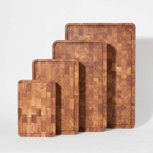 Four wooden cutting boards in sizes from small to extra large